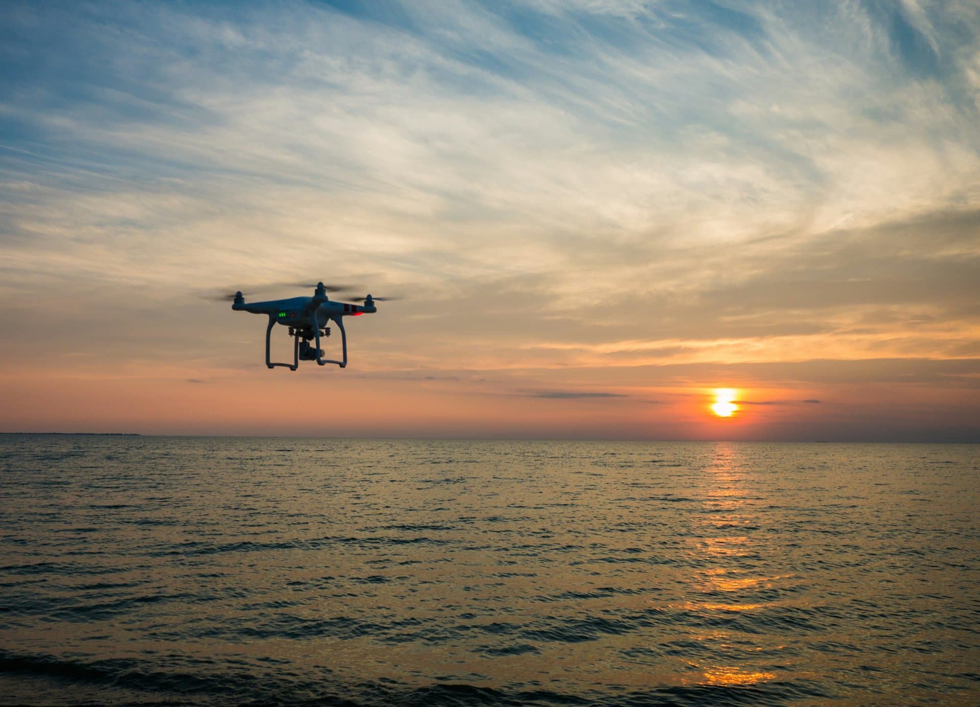 A drone over the sea at sunset