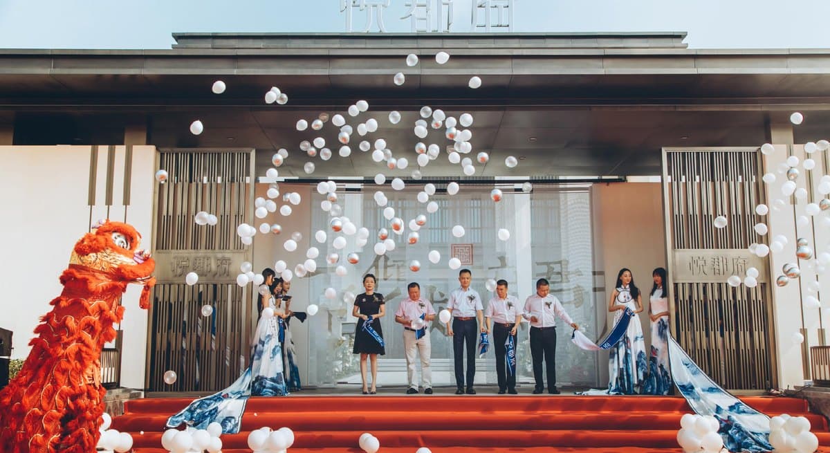 Opening ceremony: group executives and guests on stage, with the lion dance